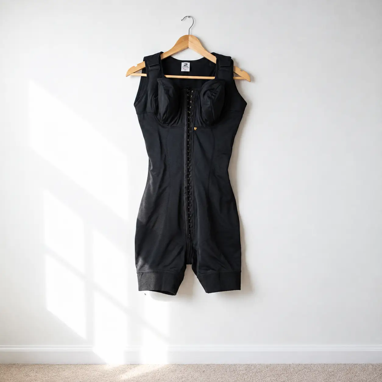 Minimalist Black Shapewear on Wooden Hanger